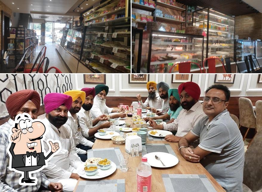 Take a seat at one of the tables at Shri Naivedyam Sweets & Bakers