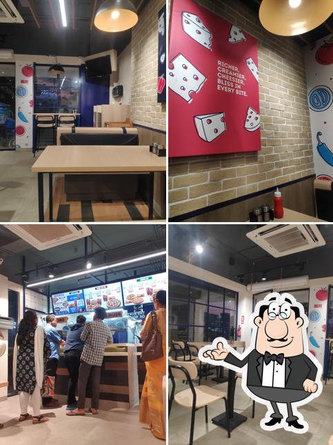 Take a seat at one of the tables at Domino's Pizza Dutta Market, Duliajan