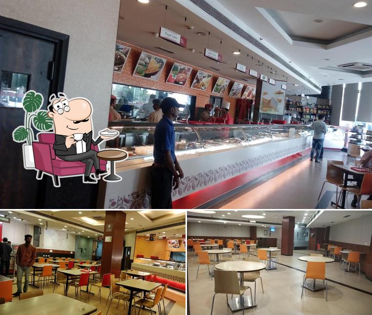 Take a seat at one of the tables at Haldiram's - Rewari