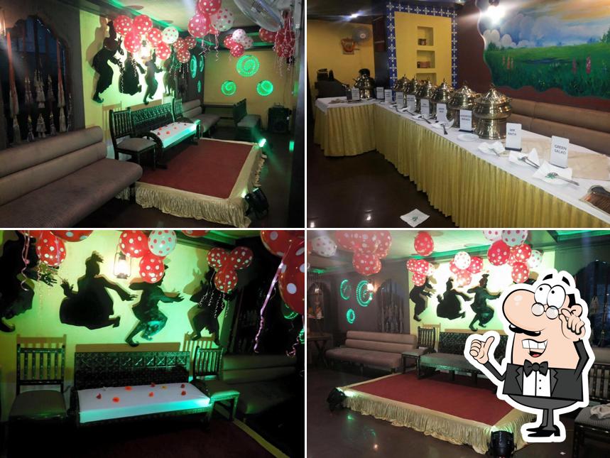 Take a seat at one of the tables at Pind Balluchi