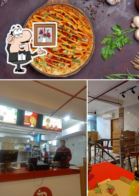 The photo of Rominus Pizza and Burger’s interior and food