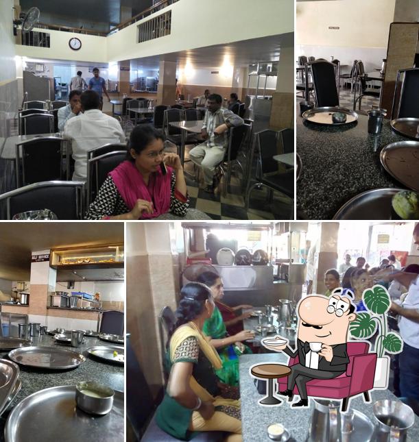 Take a seat at one of the tables at Akshaya Veg Restaurant