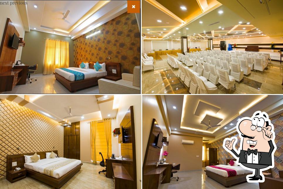 Take a seat at one of the tables at Hotel Maa Anjani Grand Inn