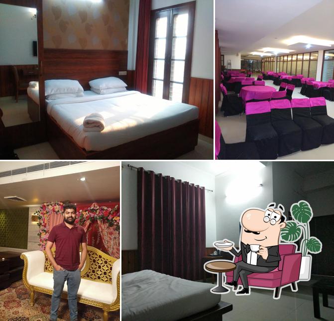 Take a seat at one of the tables at Red Apple Hotel