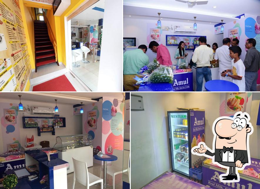 Take a seat at one of the tables at Amul Ice Cream Parlour