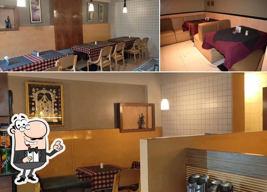 Take a seat at one of the tables at MEERA BAR & RESTAURANT