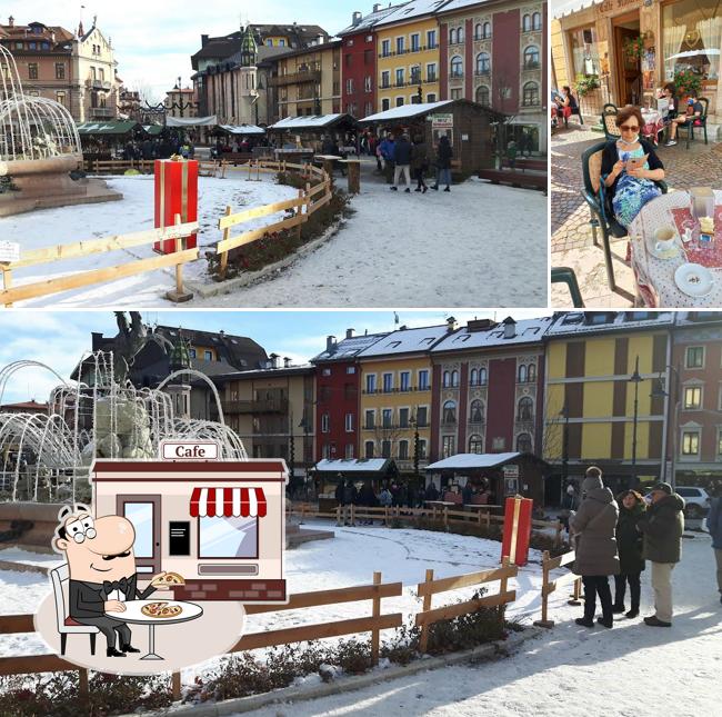 Questa è la immagine che presenta la esterno e tavolo da pranzo di Caffè Italia