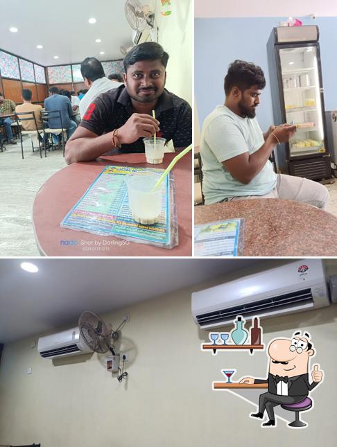 Take a seat at one of the tables at Naresh Fruit Juice and ICE Cream