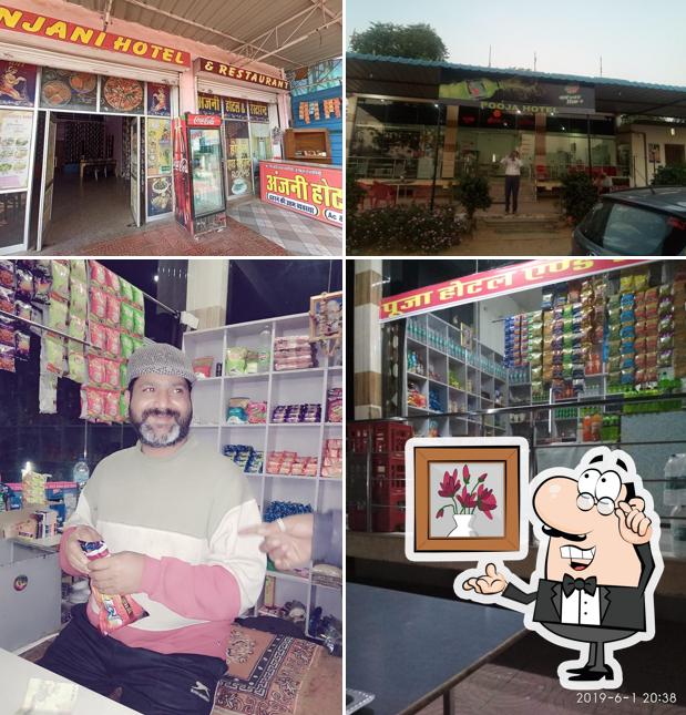 Take a seat at one of the tables at Pooja hotel & Restaurant