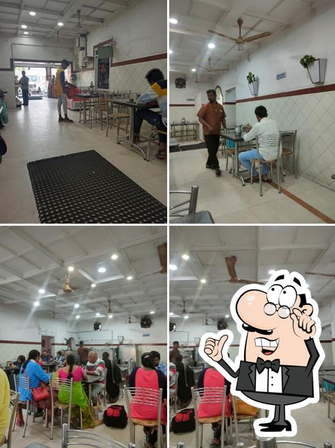 Take a seat at one of the tables at Hotel Lakshmi Narayana Bhavan