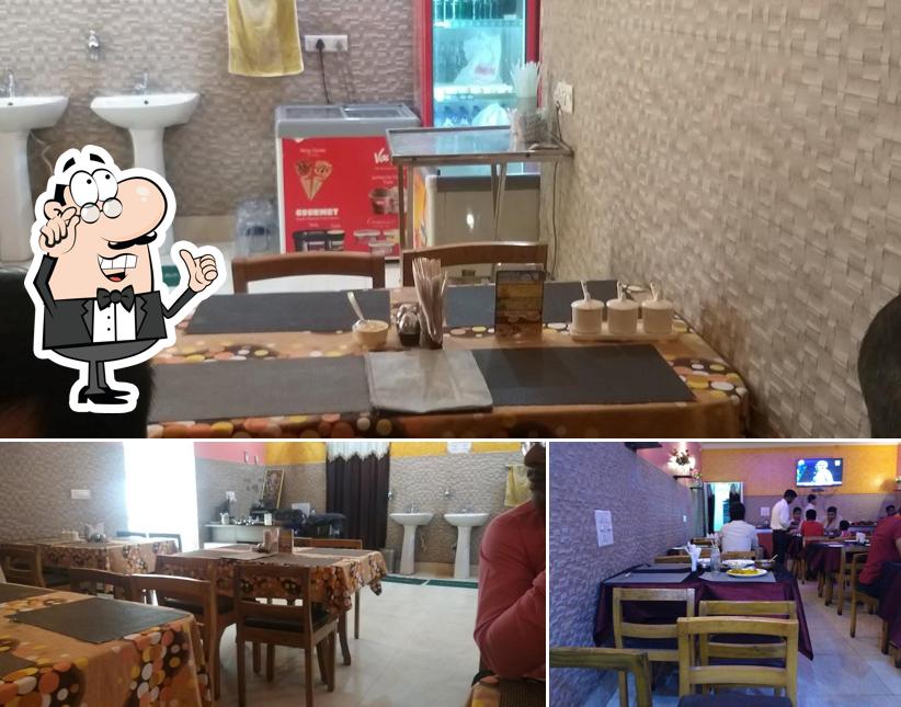 Take a seat at one of the tables at Milanee's Kitchen- Bengali Restaurant Jamshedpur