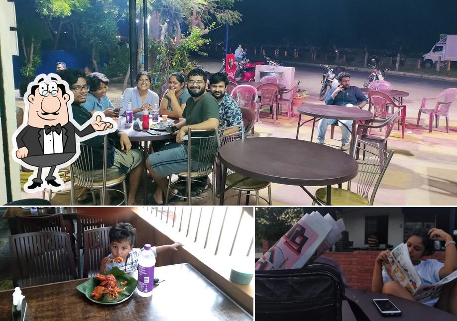 Take a seat at one of the tables at Hotel Great Amalodbhavi