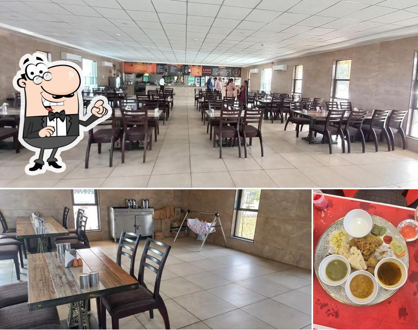 Take a look at the image depicting interior and food at Patel Ni Wadi Veg Restaurant