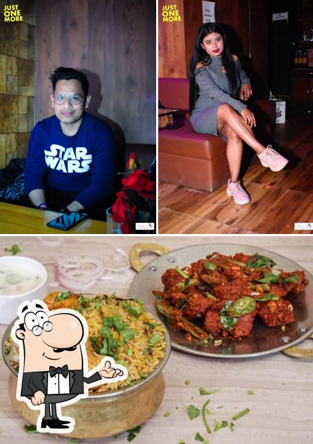 Take a look at the image depicting interior and food at Just One More
