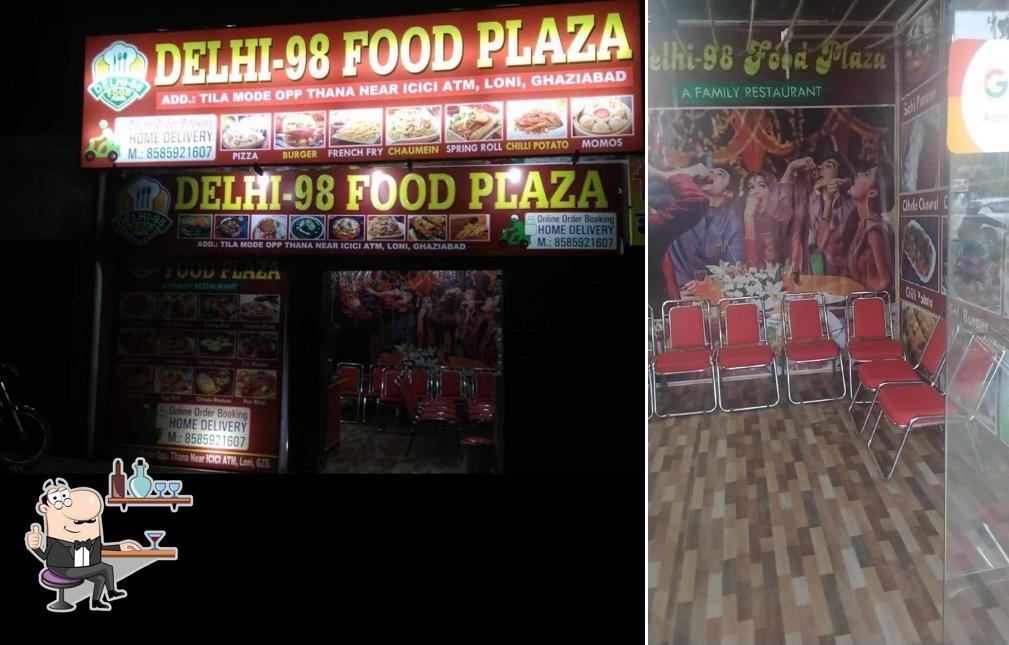 Take a seat at one of the tables at Delhi 98 Food Plaza