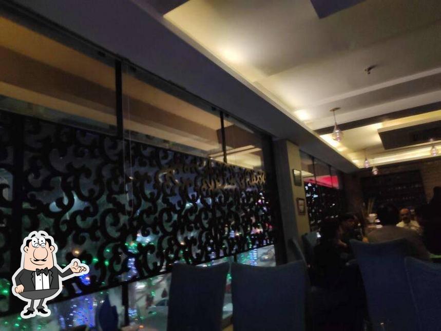 Take a seat at one of the tables at Tamara - Pipal Tree Hotel