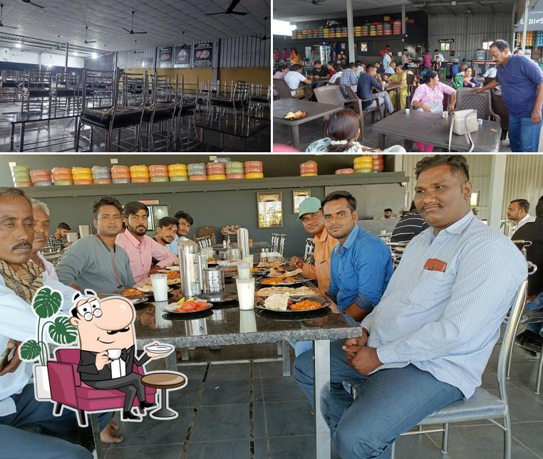 Take a seat at one of the tables at The Grand Khodiyar Restaurant / Best Restaurant in Rajkot