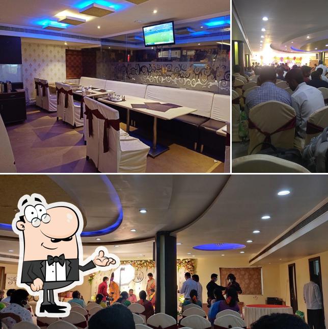 Take a seat at one of the tables at Sri Sampoorna Hotel