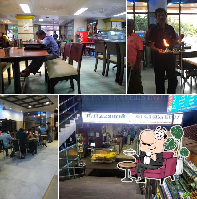 Take a seat at one of the tables at Sri Saravana Bhavan - High Class Veg