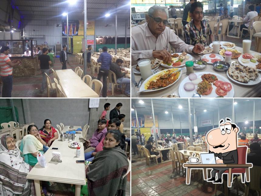 Take a seat at one of the tables at Jay Khodiyar Hotel