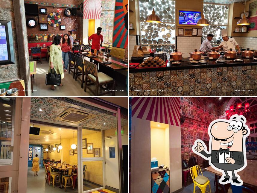 Take a seat at one of the tables at Dhaba Estd 1986 Delhi, Connaught Place