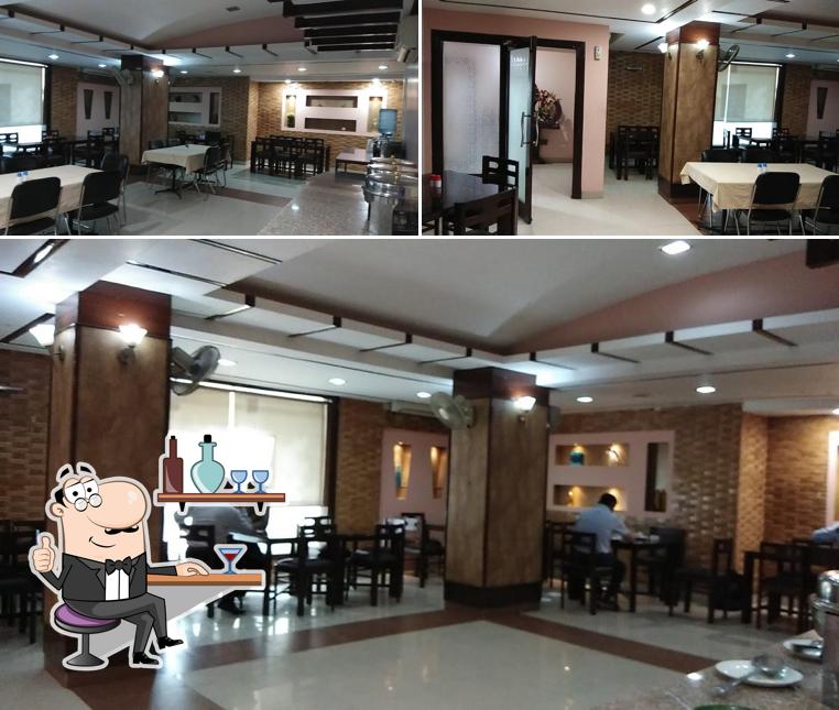 Take a seat at one of the tables at Suvidha Restaurant