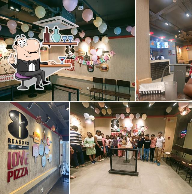 Take a seat at one of the tables at Pizza Hut Medical College Road, Davangere