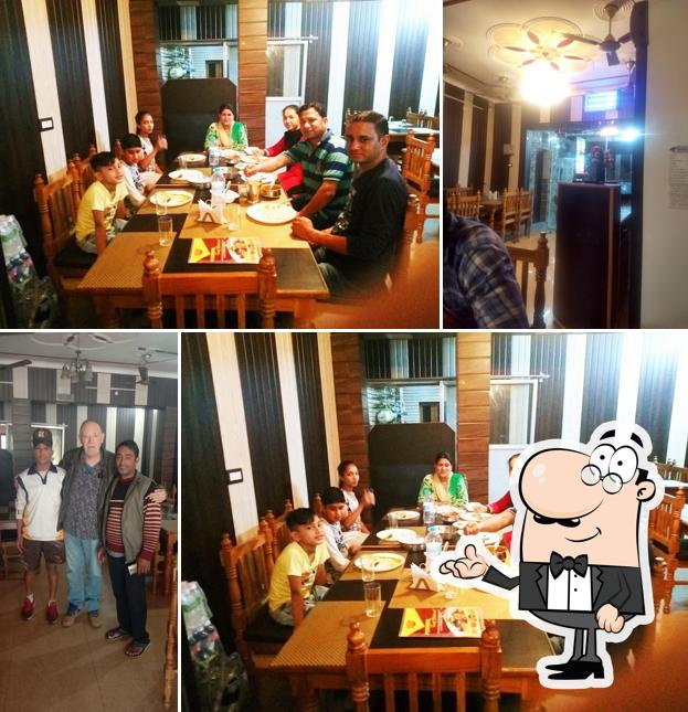 Take a seat at one of the tables at Pokhriyal Family Restaurant