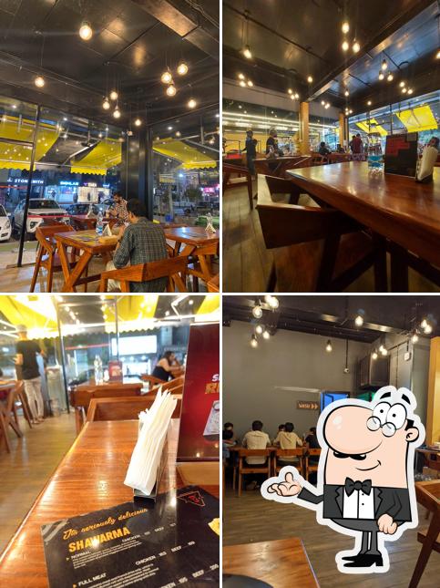 Take a seat at one of the tables at Al Taza - Kozhikode