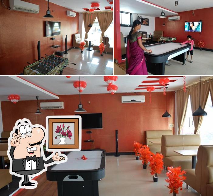 Take a seat at one of the tables at Meat And Eat - Palayapalayam