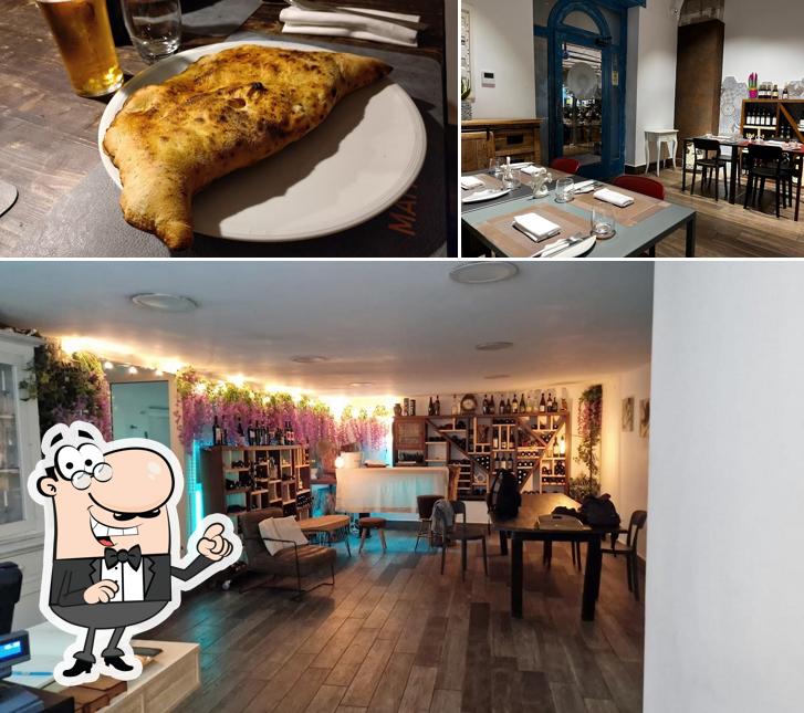 Dai un’occhiata alla foto che mostra la interni e cibo di Taverna Mafalda