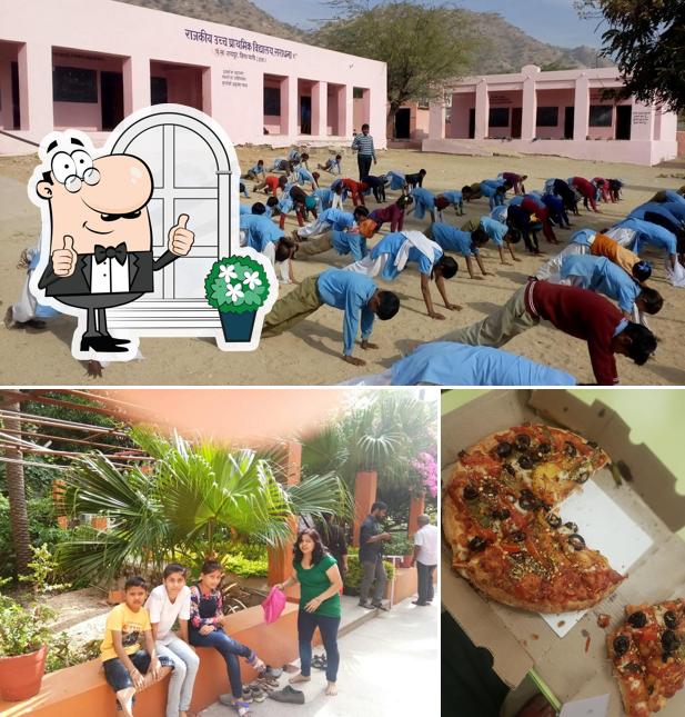 The image of exterior and pizza at Ring Leader Restaurant
