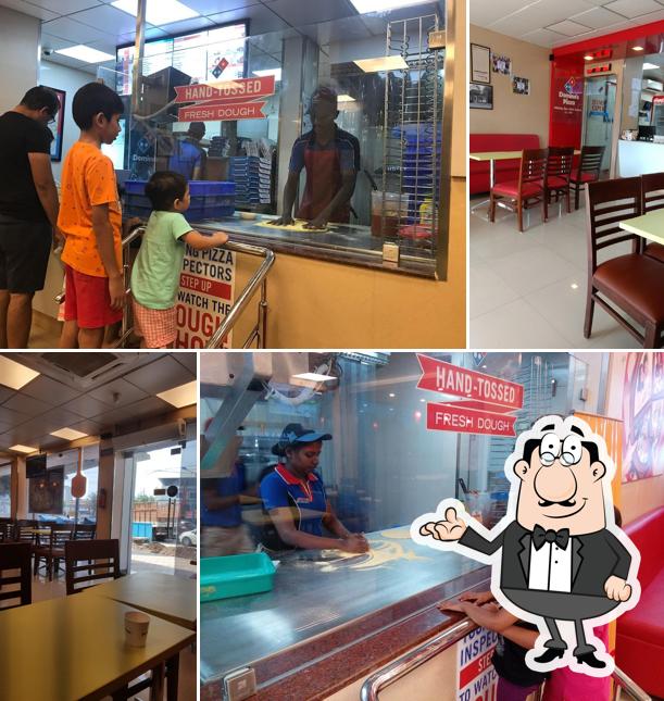 Take a seat at one of the tables at Domino's Pizza Koonamthai, Edappally