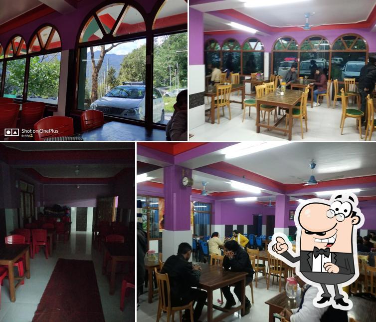 Take a seat at one of the tables at Hotel Pradeep Veg & Nonveg Restaurant
