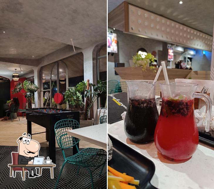 Take a seat at one of the tables at Oh My Hunger - Resto Cafe