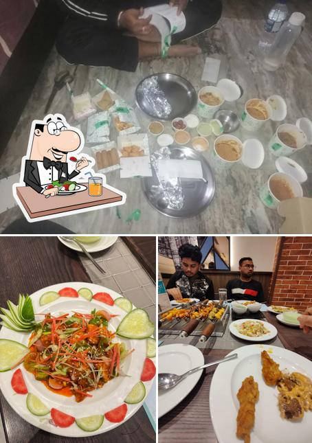 The photo of Barbeque Nation Kaushambi’s food and dining table