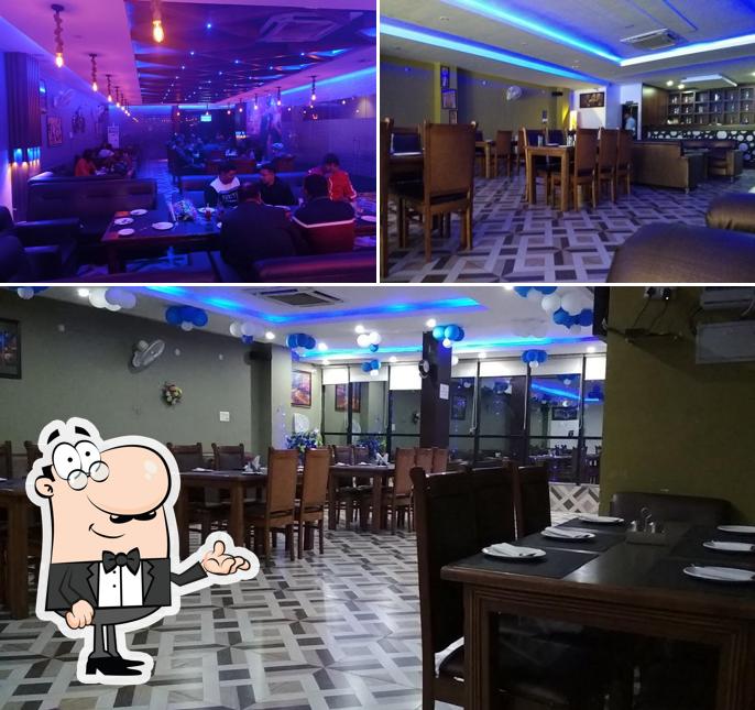 Take a seat at one of the tables at Blue Night Bar& Restaurant