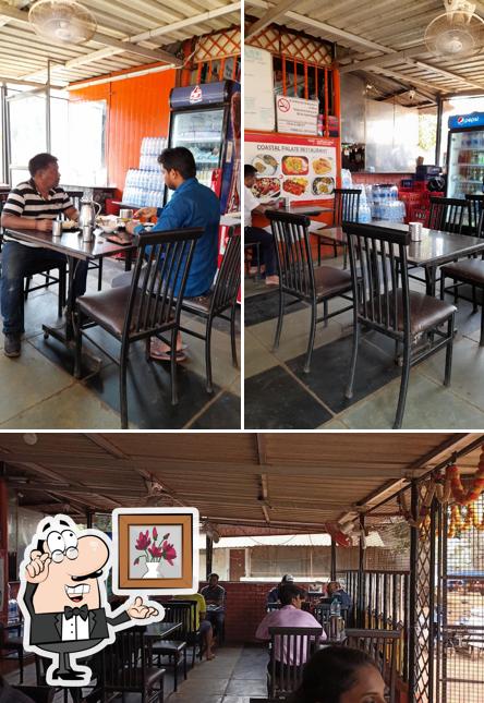 Take a seat at one of the tables at UDUPI HOTEL - Coastal Palate