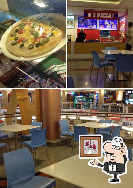 This is the photo depicting interior and food at US Pizza