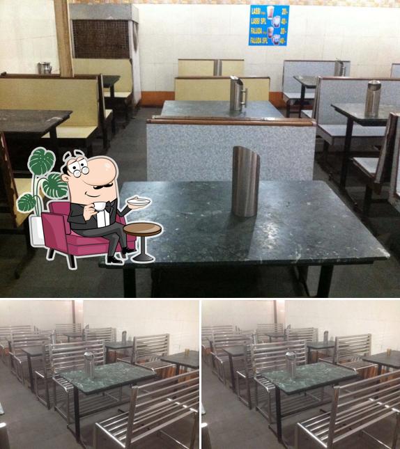 Take a seat at one of the tables at Farasha Cafe And Bakery