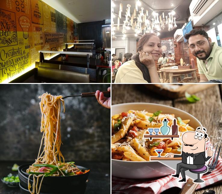 Take a seat at one of the tables at PIZZA ZONE, KALOL