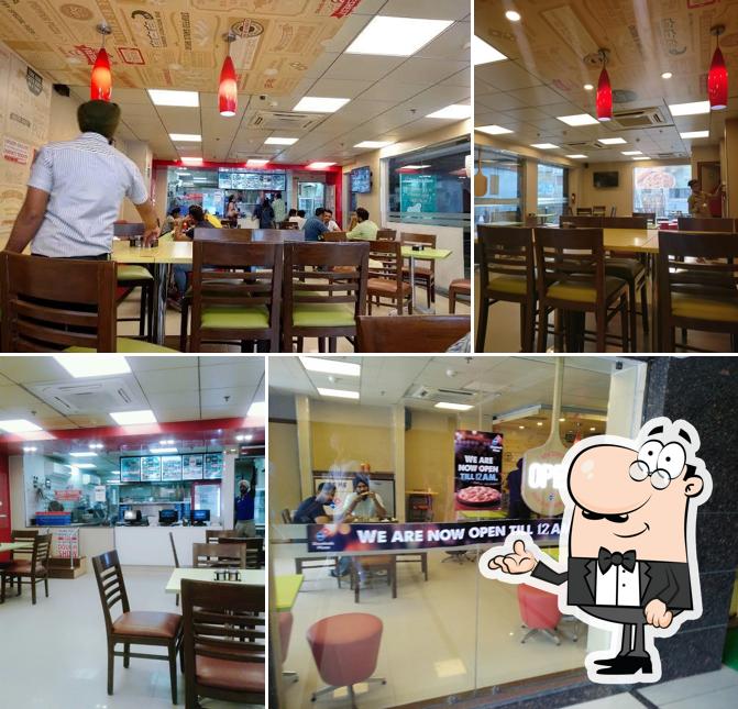 Take a seat at one of the tables at Domino's Pizza Guru Ram Das Market, Moga