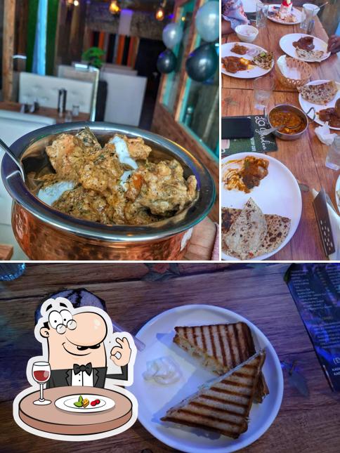 Among various things one can find food and dining table at La Garden Restaurant and Rooftop cafe