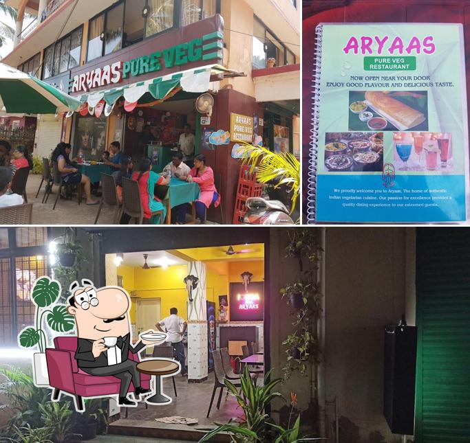 Take a seat at one of the tables at Aryaas Veg Restuarant