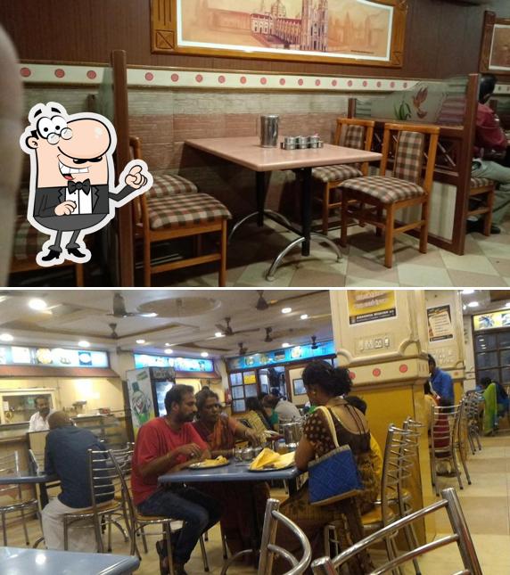 Take a seat at one of the tables at Hotel Anandha Bhavan