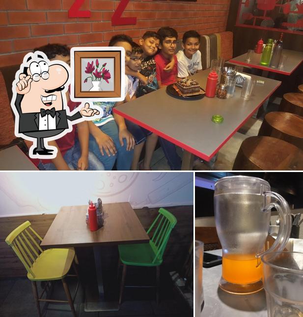 Take a look at the picture displaying interior and beer at PIZZA ZONE