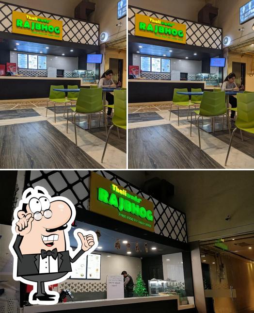 Take a seat at one of the tables at RAJBHOG by Thaliwada