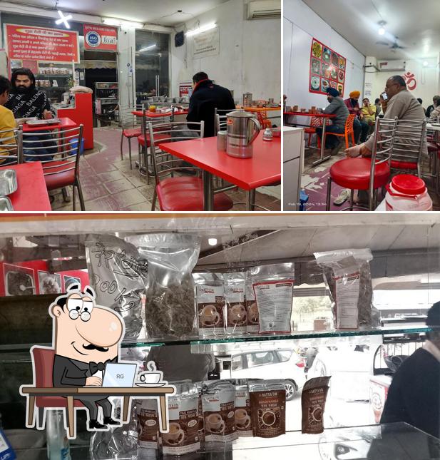 Take a seat at one of the tables at Satya Om Pure Ghee Veg Restaurant