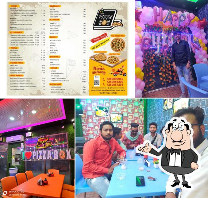 Take a seat at one of the tables at The Pizza Box Mahoba