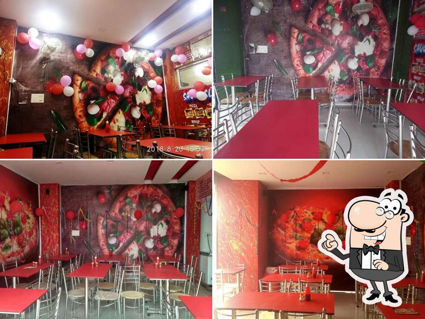 Take a seat at one of the tables at saucy Slice Pizza